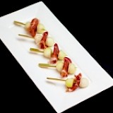 Krulspies met serranoham en meloen